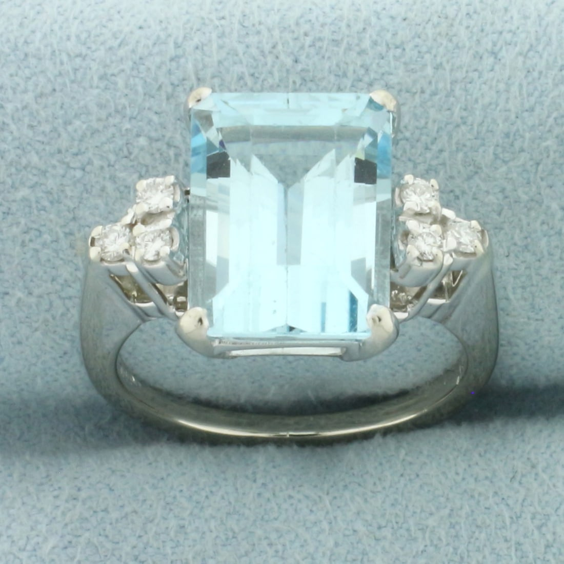 Aquamarine and Diamond Ring in 14k White Gold: In 14k white gold. Contains one high quality natural 5ct emerald cut Aquamarine gemstone, 12mm by 9mm, with bright color and excellent clarity. Also contains six high quality .02ct diamonds, VS clarit