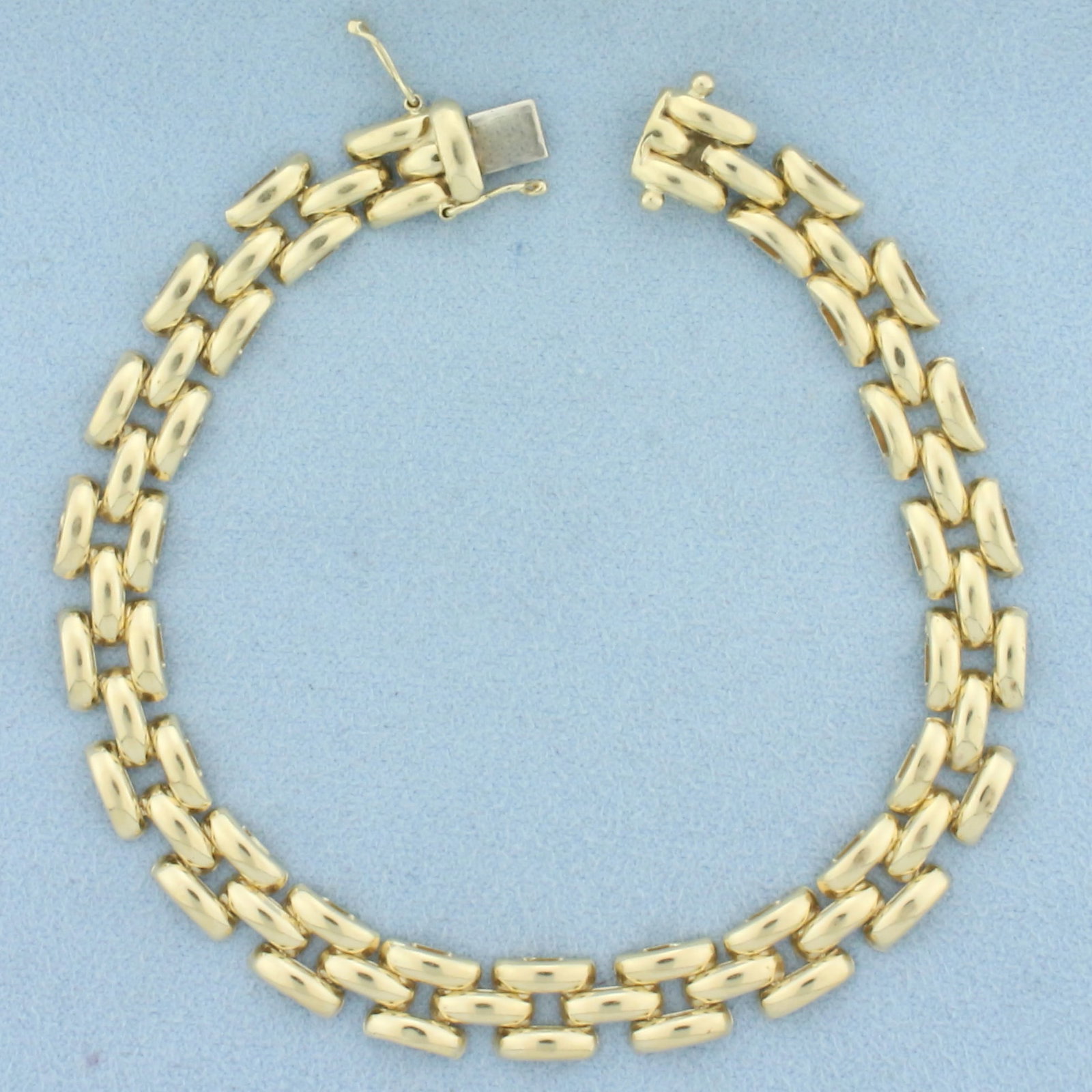 Italian Panther Link Bracelet in 14k Yellow Gold: In 14k yellow gold. Italian made. 7 5/8 inches long and 1/4 inches wide. Concealed slide clasp with 2 safety latches. 12.5g.