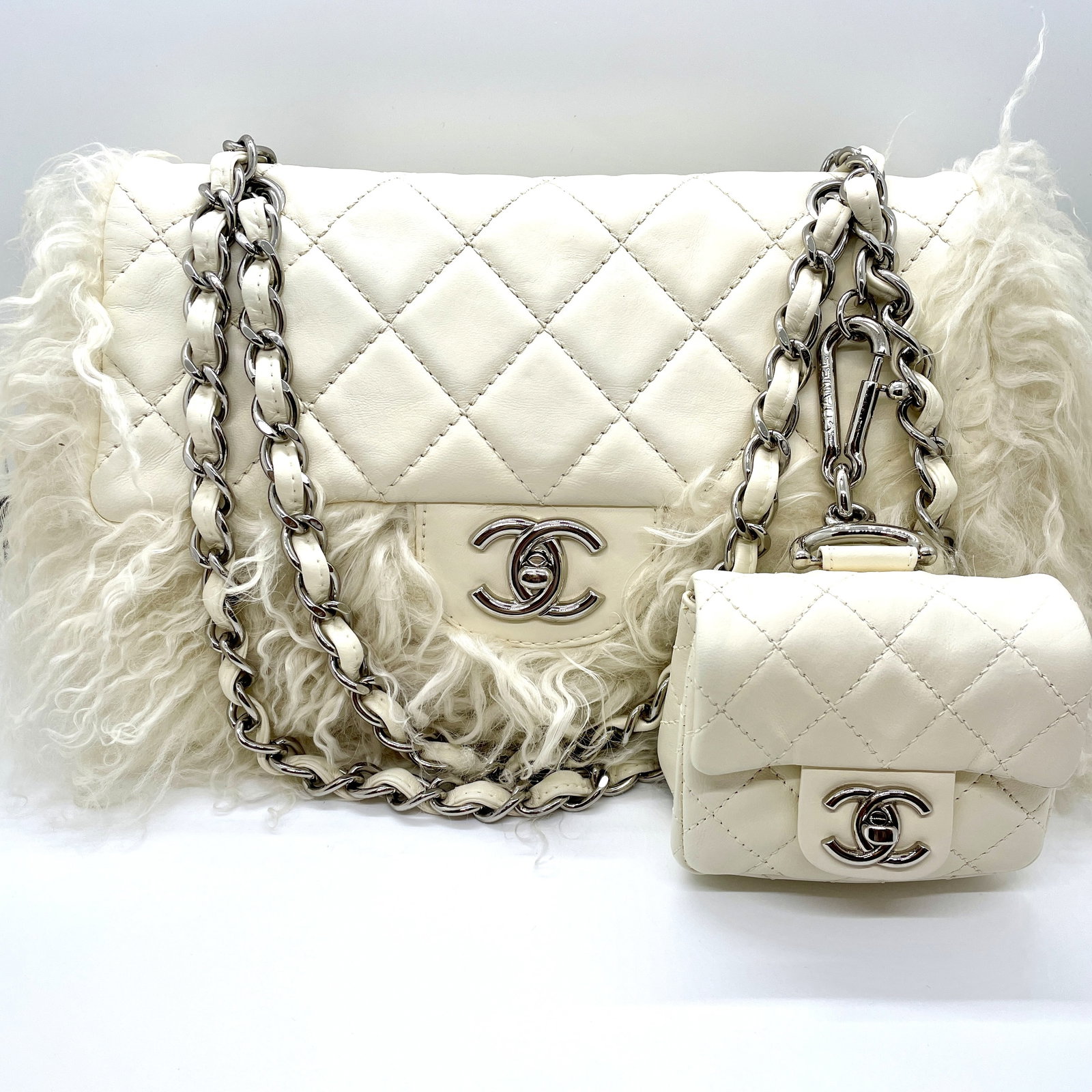 Chanel White Tibet Lambskin Classic Medium Flap Mongolian Fur with Micro Flap Bag: Guaranteed authentic with hologram sticker in bag (#12******). Ultra rare collector's bag set from Karl Lagerfeld. Shiny silver hardware. Iconic CC turnlocks on both bags. Main bag is approx. 11" x 7"