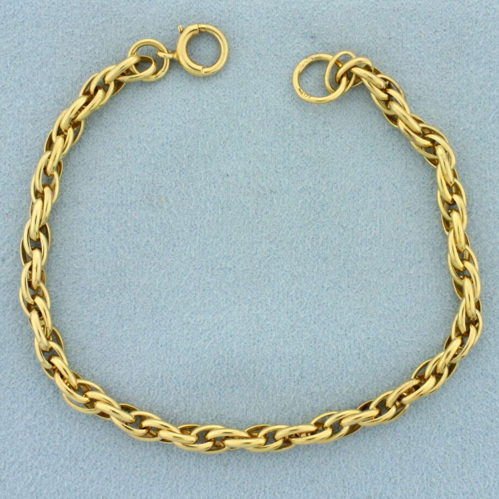 Twisting Cable Link Bracelet in 14k Yellow Gold: In 14k yellow gold. Can be used as charm bracelet. 7.5 inches long, 4mm wide. Spring clasp. 8.9g.