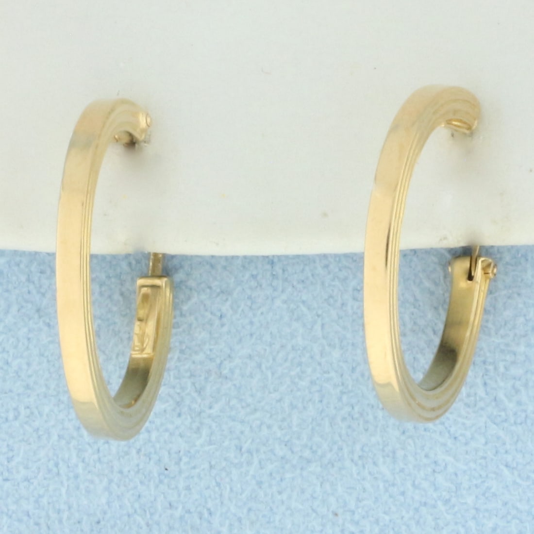 Lined Design Hoop Earrings in 18k Yellow Gold: In 18k yellow gold. 3/4 inch diameter, 2mm wide. Unique lined design on side. 2.2g.