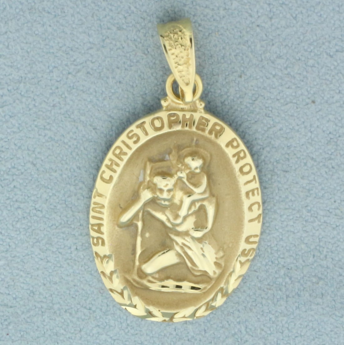 St. Christopher Protect Us Pendant in 14k Yellow Gold: In 14k yellow gold. 1 3/8 inches long x 3/4 inches wide. Diamond cut design for added reflection. 4.0g.
