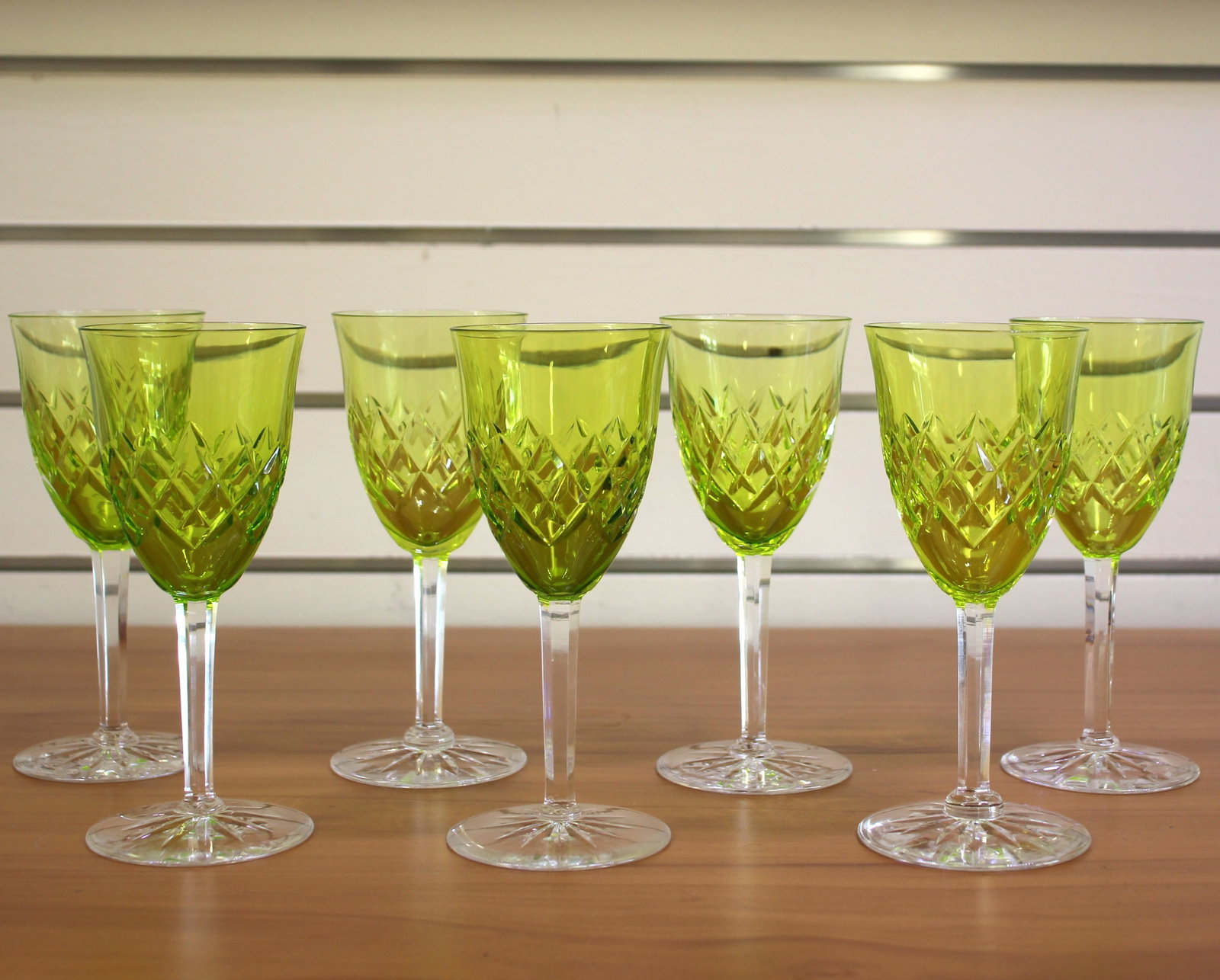 9 Piece Orrefors Helga Chartreuse Green Scandinavian Wine Glass Set: Contains nine 5 7/8 inch wine glasses. Signed. In excellent condition, one piece has minor imperfection on rim.