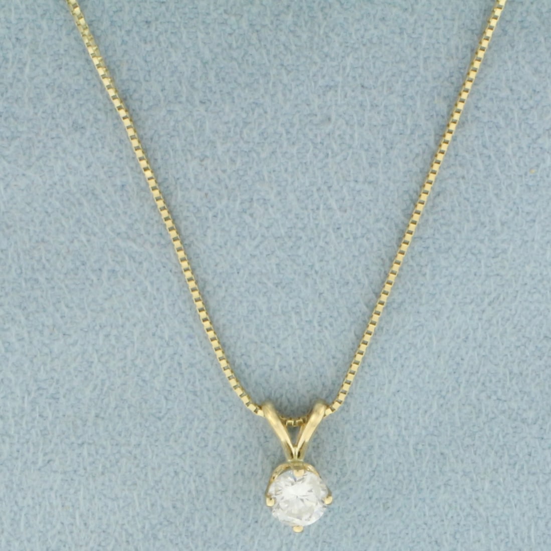 Diamond Solitaire Necklace in 14k Yellow Gold: In 14k yellow gold. Italian made. Contains 1 high quality 1/4ct diamond, SI2 clarity/H color. Box link chain 22 inches long and .65mm wide. Spring ring clasp. 1.5g.