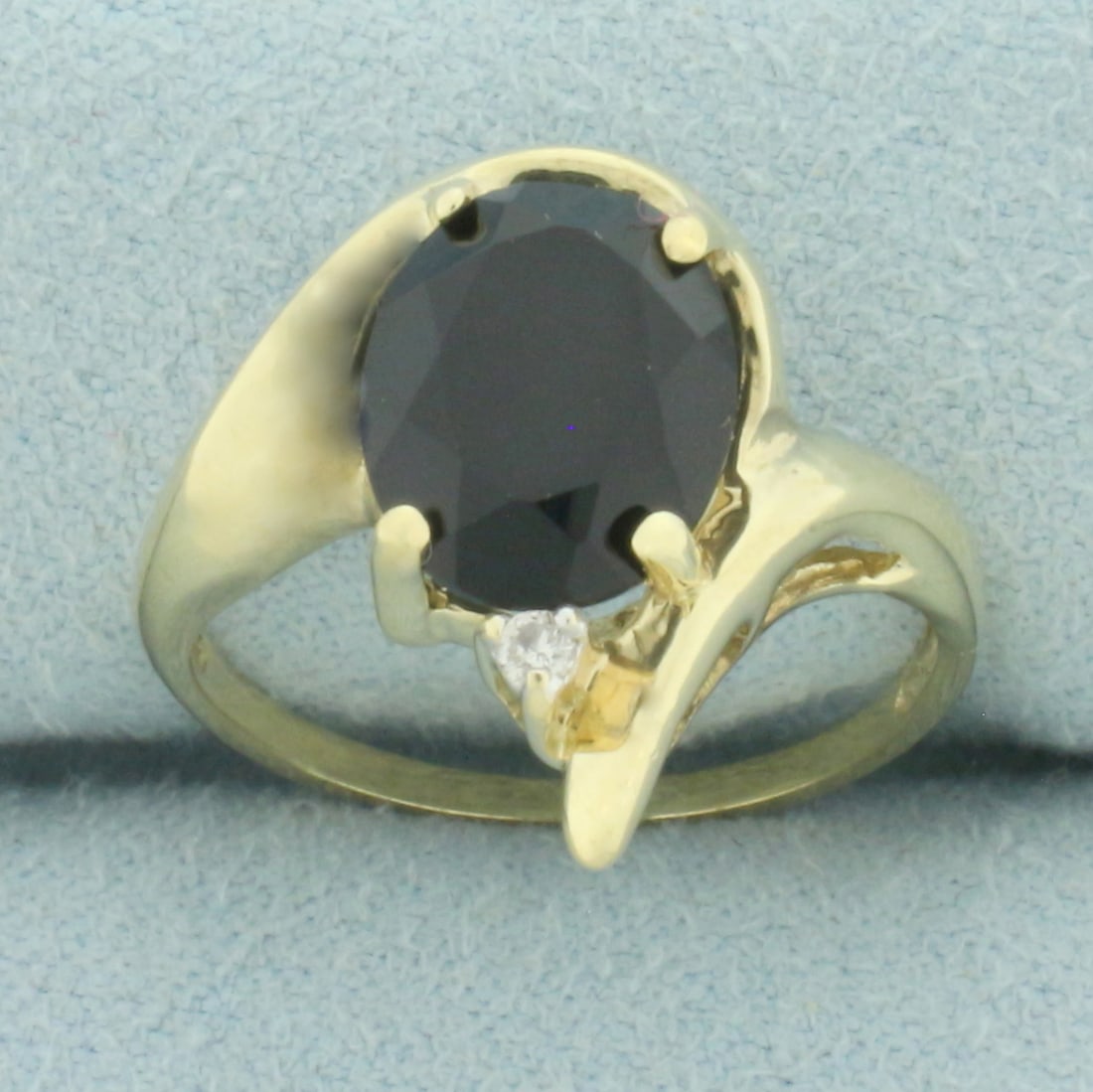 Black Tourmaline and Diamond Ring in 10k Yellow Gold: In 10k yellow gold. Contains one 10mm by 8mm high quality black Tourmaline gemstone. Also contains one high quality .03ct diamond, H color/I clarity. Size: 6. 2.7g.