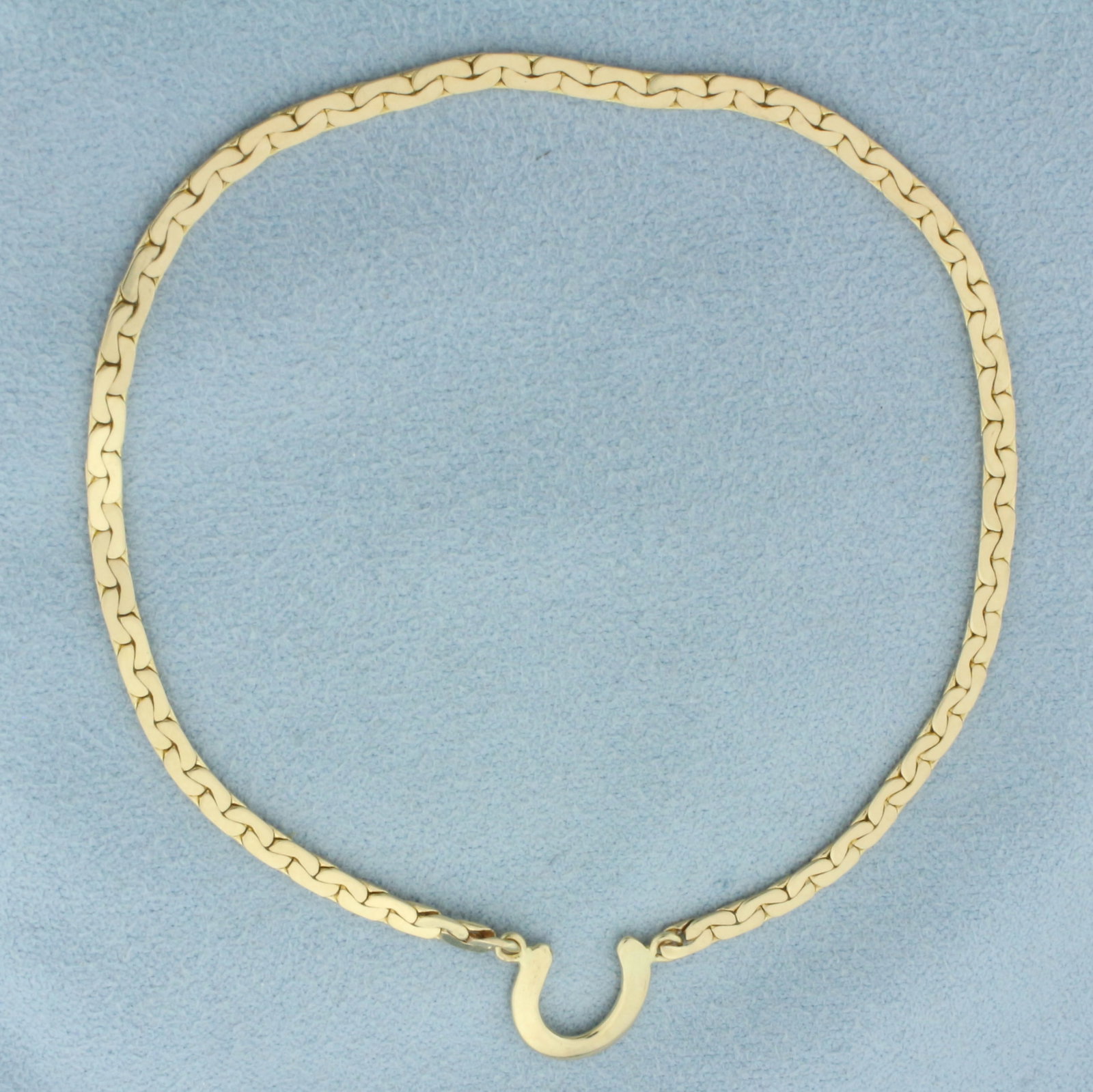 Lucky Horseshoe Bracelet in 14k Yellow Gold: In 14k yellow gold. 8 inches long and 2.2mm wide chain. Note that this is a slide on bracelet, no clasp. 4.1g.
