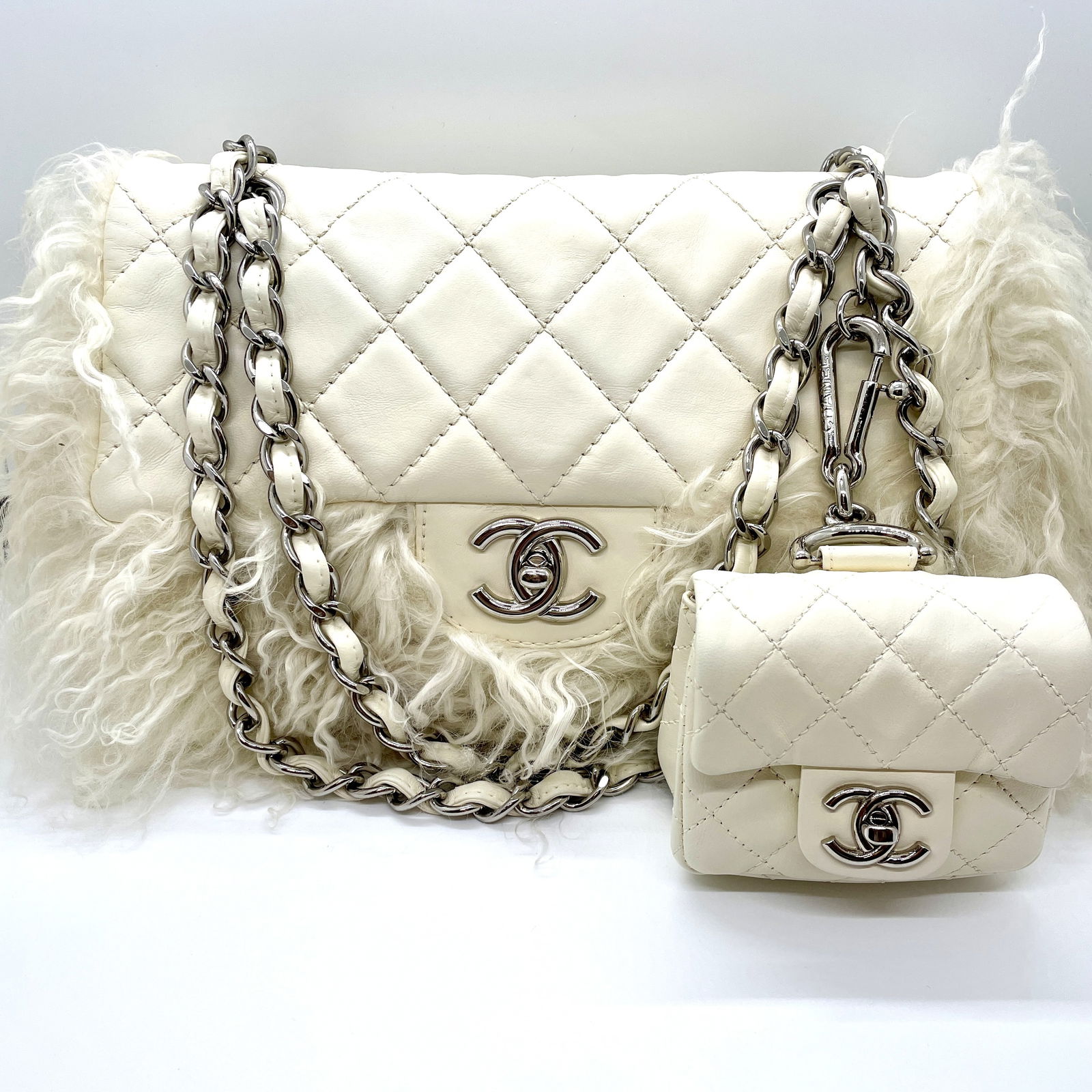 Chanel White Tibet Lambskin Classic Medium Flap Mongolian Fur with Micro Flap Bag: Guaranteed authentic with hologram sticker in bag (#12******). Ultra rare collector's bag set from Karl Lagerfeld. Shiny silver hardware. Iconic CC turnlocks on both bags. Main bag is approx. 11" x 7"