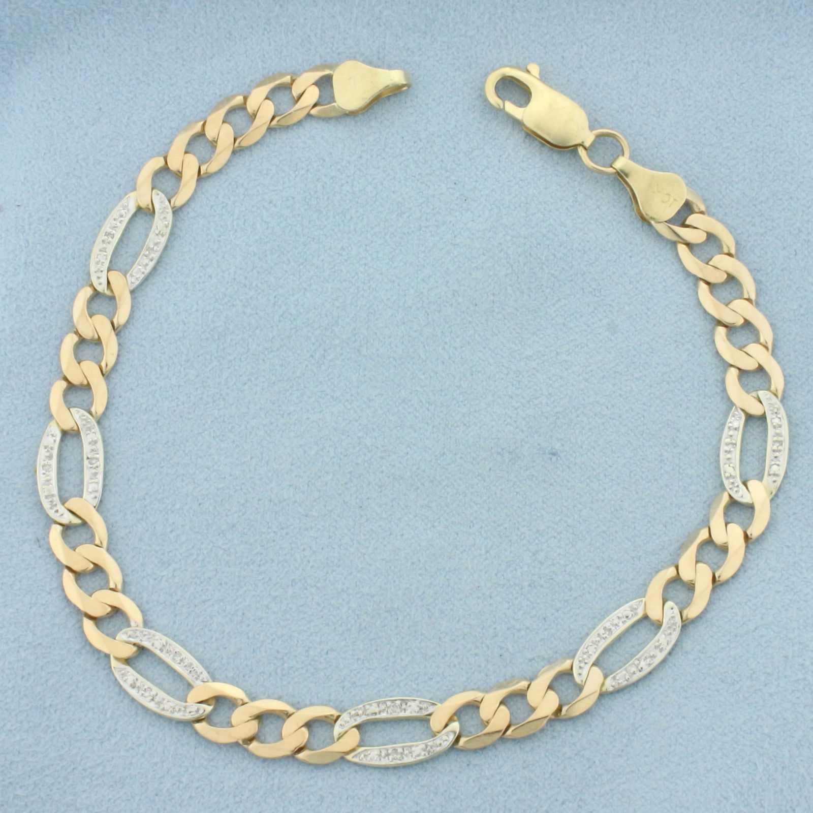 Diamond Figaro Link Anklet in 10k Yellow and White Gold: In 10k yellow and white gold. Contains twelve high quality 1/2pt diamonds. 8 5/8 inches long and 7mm wide. Lobster clasp. 9.0g.