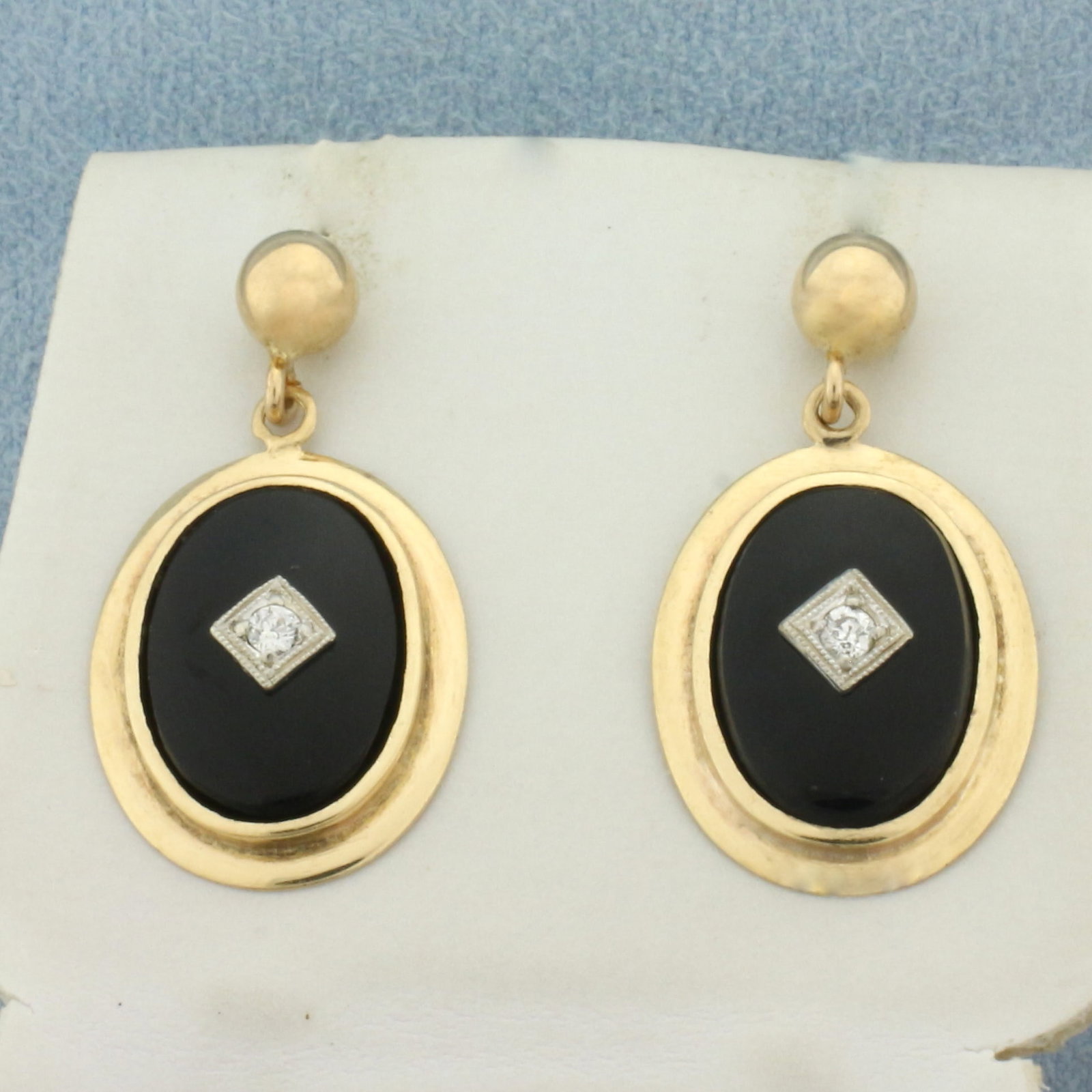 Vintage Onyx and Diamond Dangle Earrings in 14k Yellow Gold: In 14k yellow gold. Contains two high quality 13mm Onyx gemstones Also contains two high quality .03ct Old European Cut Diamonds, SI clarity/G color. 1 inch long and 1/2 inch wide. Screw backs. 4.0g.