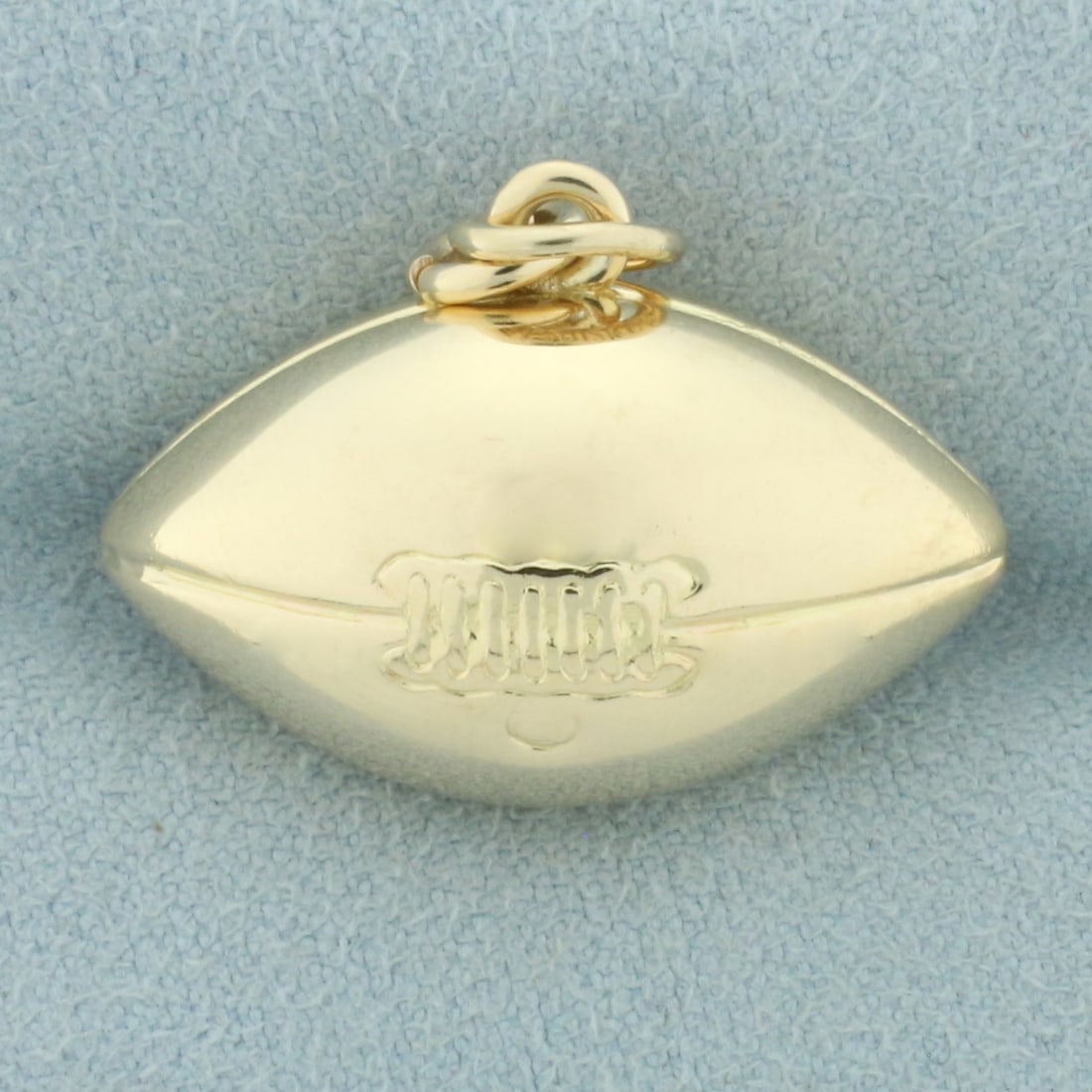 Vintage 3D Football Pendant or Charm in 10k Yellow Gold: In 10k yellow gold. 7/8 inches long x 1 inch wide. 4.4g.