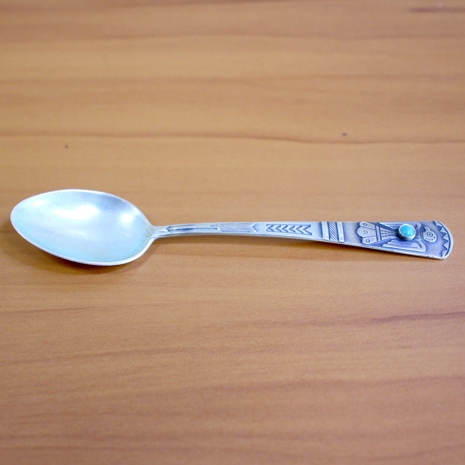 Sterling Silver Turquoise Navajo Spoon: In .925 Sterling Silver. 4 3/8 inches long. Contains one high quality 4mm cabochon turquoise gemstone. 12.2g.