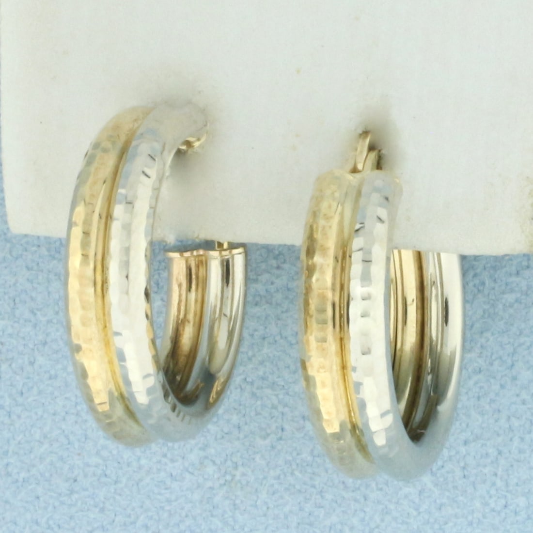 Diamond Cut Double Hoop Earrings in 10k Yellow and White Gold: In 10k yellow and white gold. 3/4 inch diameter. 5mm wide. Diamond cut for added reflection. 2.1g.
