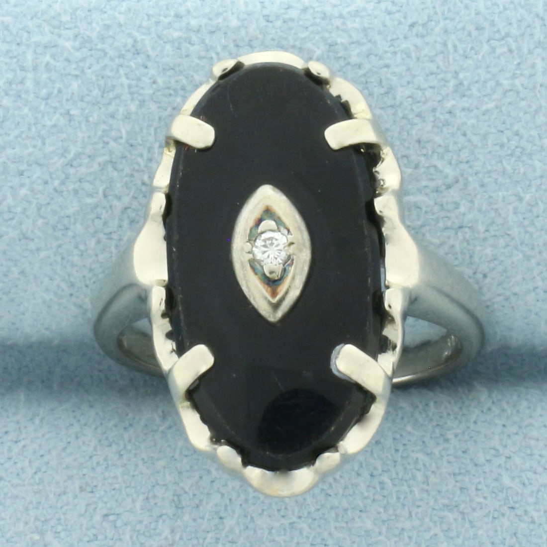 Vintage Onyx and Diamond Ring in 10k White Gold: In 10k white gold.20mm by 10mm, oval onyx plaque. Also contains one high quality .01ct diamond, SI clarity/G color. Size: 5.75. 3.9g.