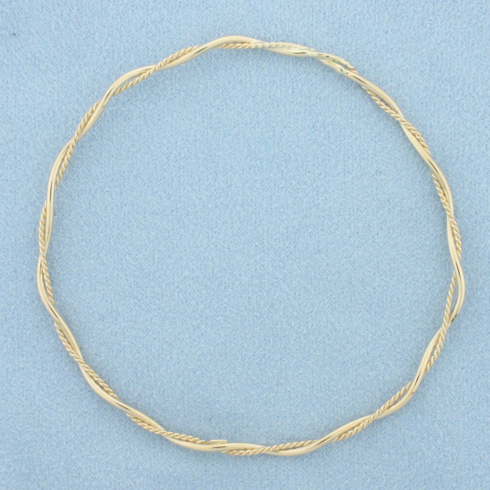 Twisting Rope Design Bangle Bracelet in 14k Yellow Gold: In 14k yellow gold. 2 5/8 inch diameter, 2.5mm wide. 2.8g.