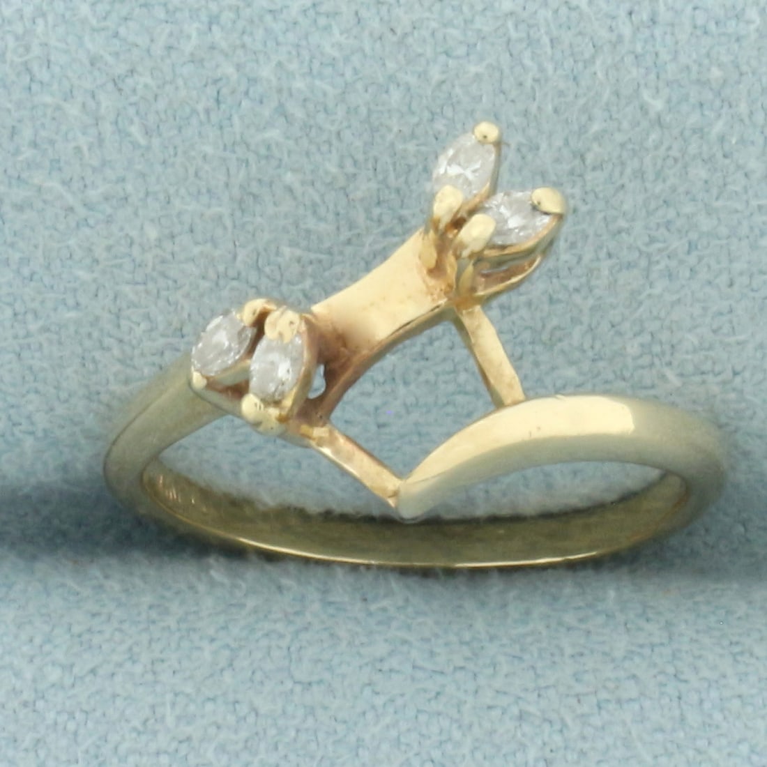 Diamond Ring Jacket in 14k Yellow Gold: In 14k yellow gold. Contains four high quality 2.5mm marquise shaped diamonds, SI clarity/H color. Designed to fit around solitaire diamond ring to give it a new look. Size: 5. 2.1g.