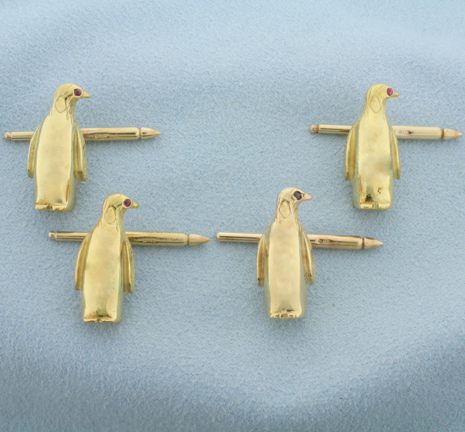 Penguin Tuxedo Stud Set in 14k Yellow Gold: In 14k yellow gold. Each penguin is 7/8 inches long. Each contains a 1.5mm high quality natural ruby gemstone as an eye. 32.0g.