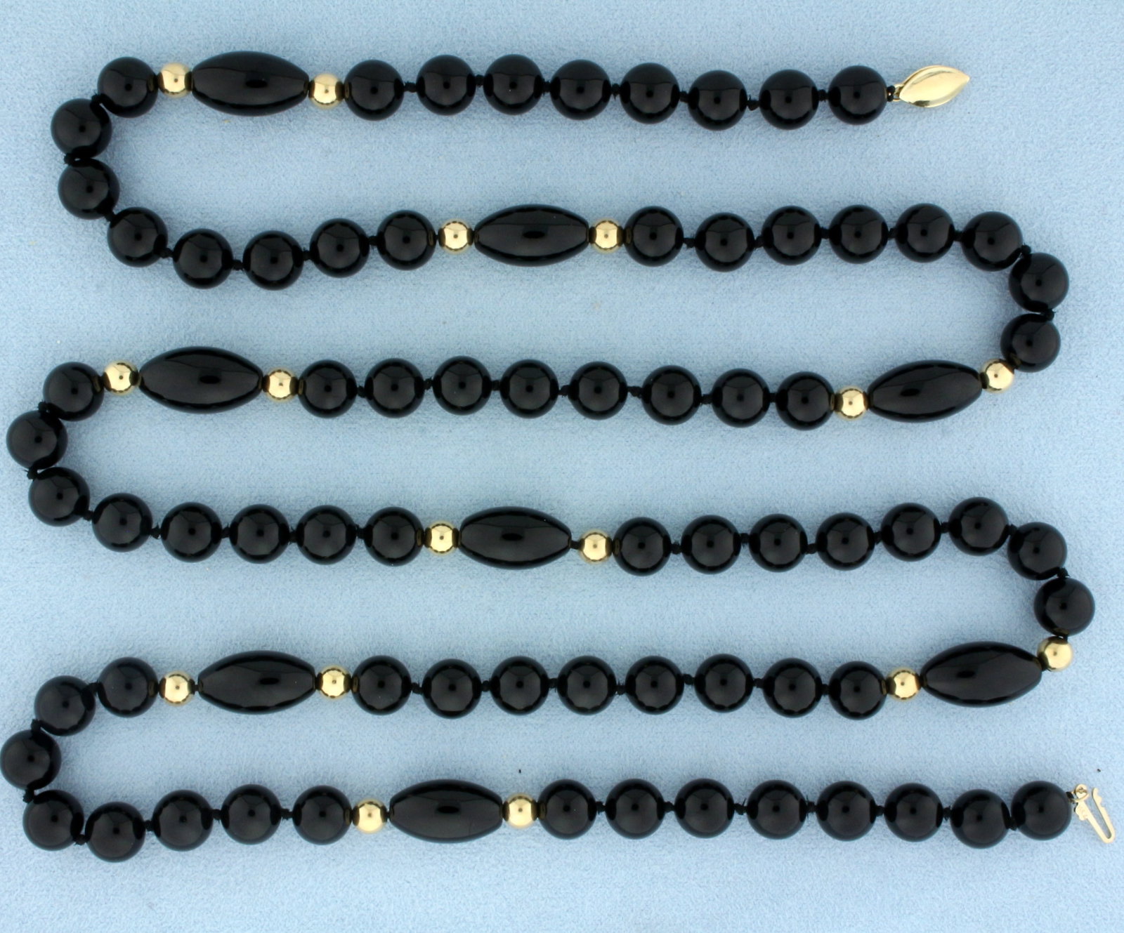 35 Inch Onyx and Gold Bead Hand Knotted Necklace in 14k Yellow Gold: In 14k yellow gold. Unique design with 8mm round and 17mm oval high quality onyx gemstones along with 5mm gold ball beads. 65.8g.