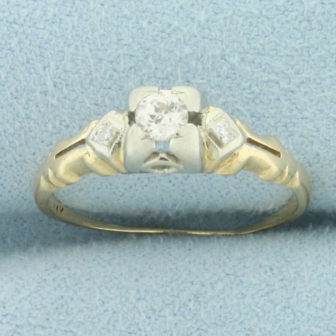 Antique 3 Stone Diamond Engagement Ring in 14k Yellow Gold: In 14k yellow gold. Contains one high quality 1/5ct old European cut diamond, SI1 clarity/H color. Also contains two high quality .02ct single cut diamonds of similar high quality. 5.8mm wide at front