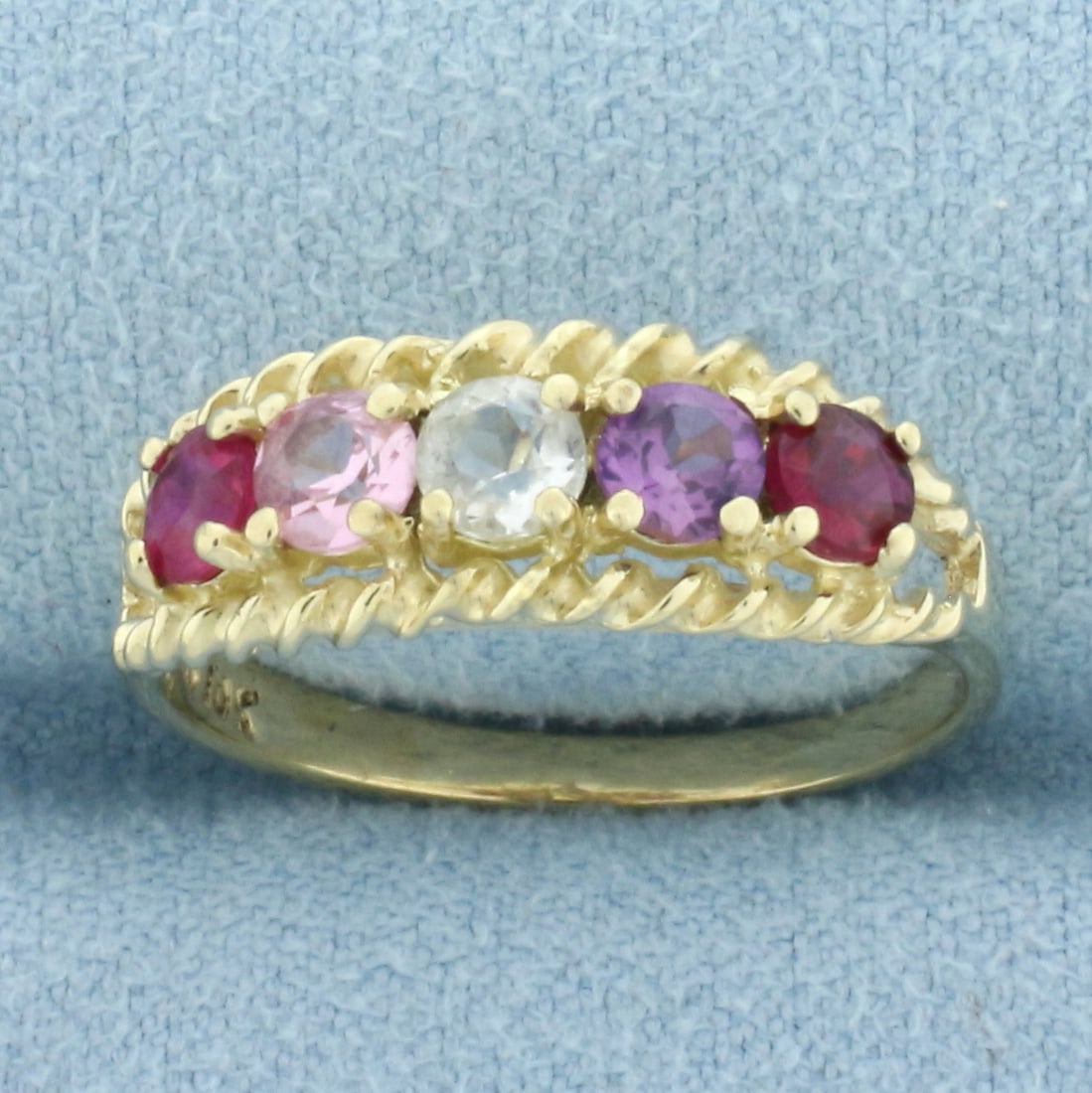 Rainbow Lab Ruby Ring in 10k Yellow Gold: In 10k yellow gold. Contains five high quality 3.5mm Lab Ruby gemstones in various colors with excellent clarity. 7mm wide at widest point. Size 7. 2.3g.