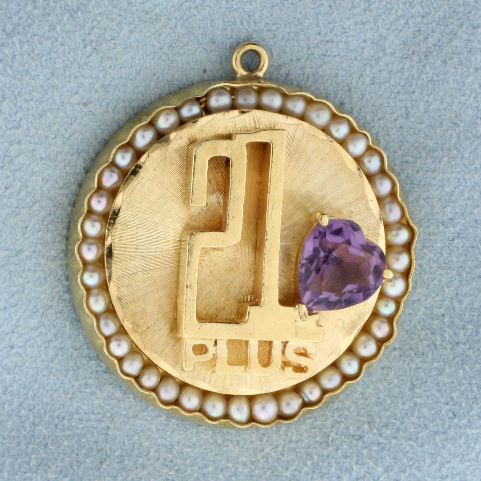 21 Plus Amethyst and Pearl Heart Pendant in 14K Yellow Gold: In 14K Yellow Gold. Contains one high quality natural 8 x 9mm heart shaped Amethyst gemstone with beautiful pastel purple color and excellent clarity. Also contains forty high quality 1.8mm seed Pearl