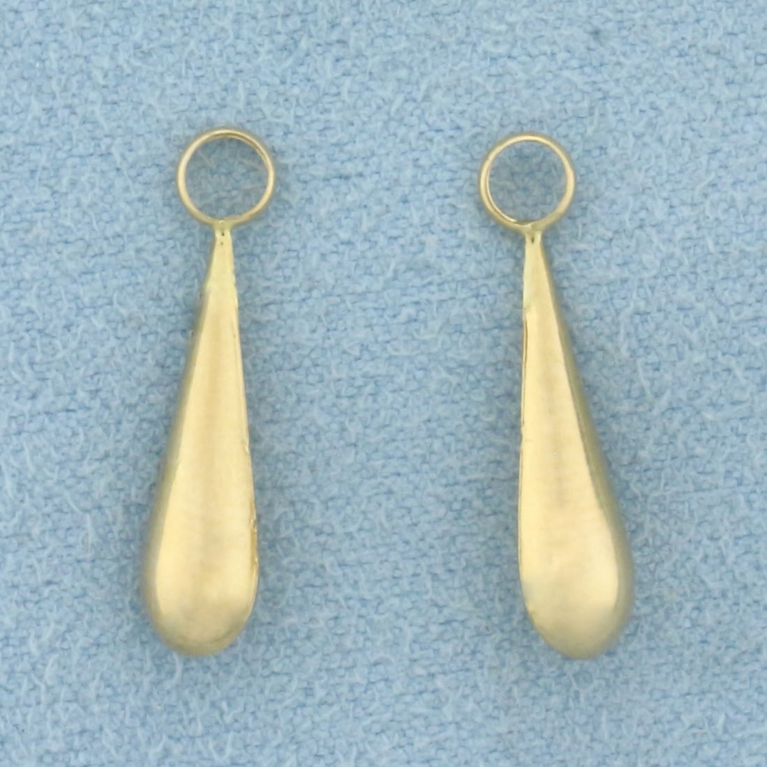 Teardrop Stud Earring Enhancers in 14k Yellow Gold: In 14k Yellow Gold. 3/4 inch long. 1/8 inch wide. Made to hang from diamond stud earrings to give a new look. .4g.