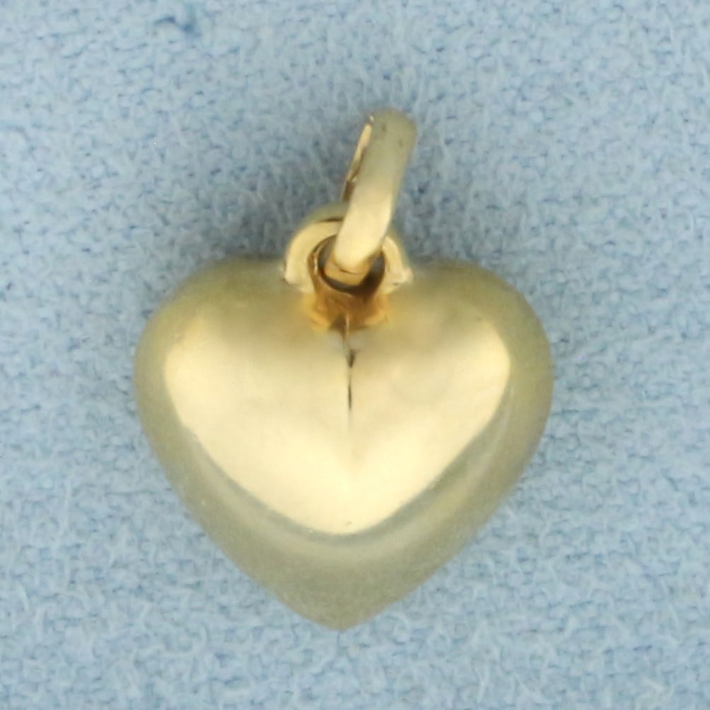 3-D Heart Pendant or Charm in 14k Yellow Gold: In 14k yellow gold. 1 inch long and 3/8 inch wide. 0.9g.