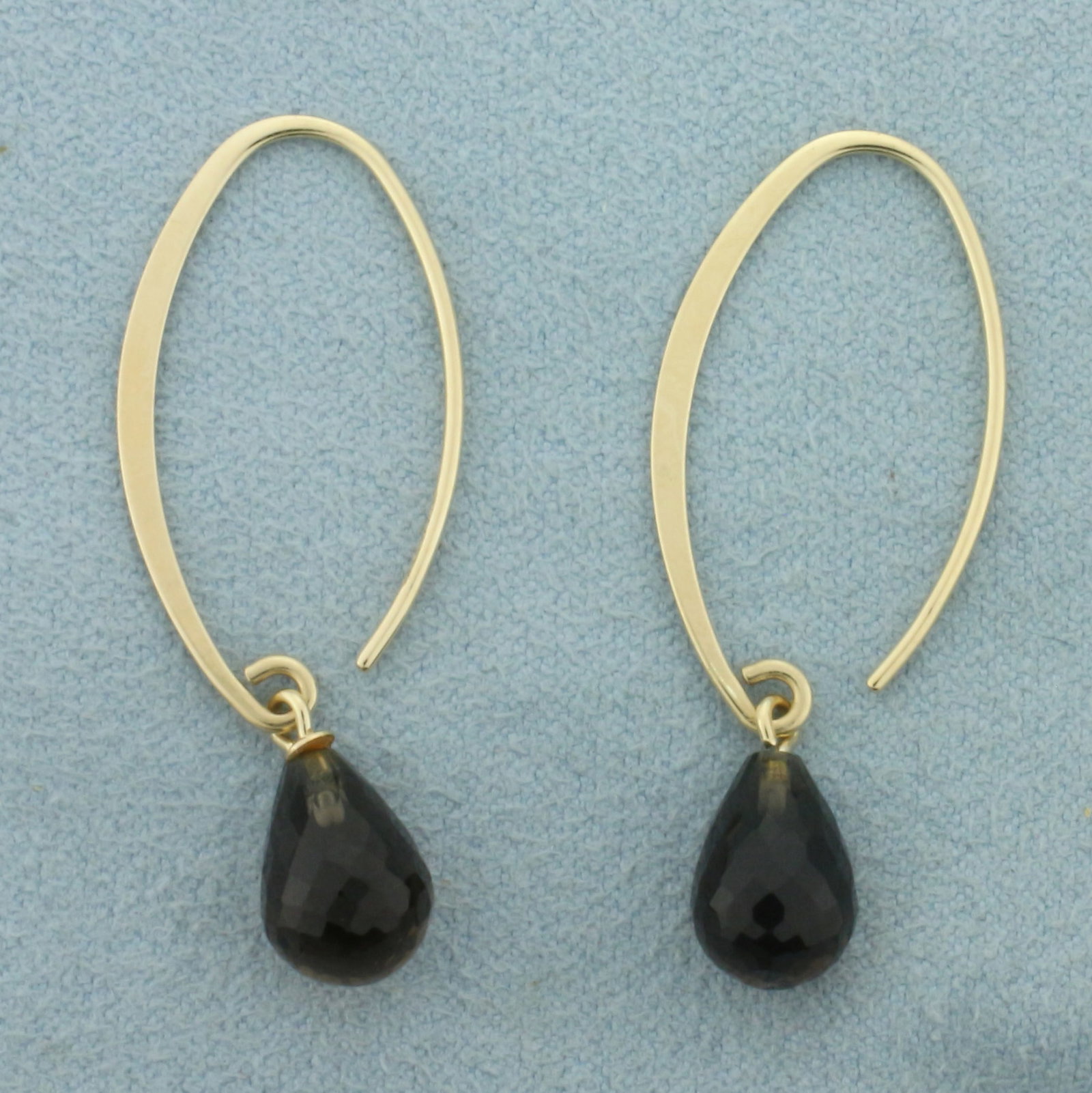 Earwire Smoky Topaz Hoop Earrings in 14k Yellow Gold: In 14k yellow gold. Contains two high quality 10mm by 7mm teardrop checkerboard faced smoky quartz gemstones. 1.5 inches long and 1/4 inches wide. Earwire. 2.4g.