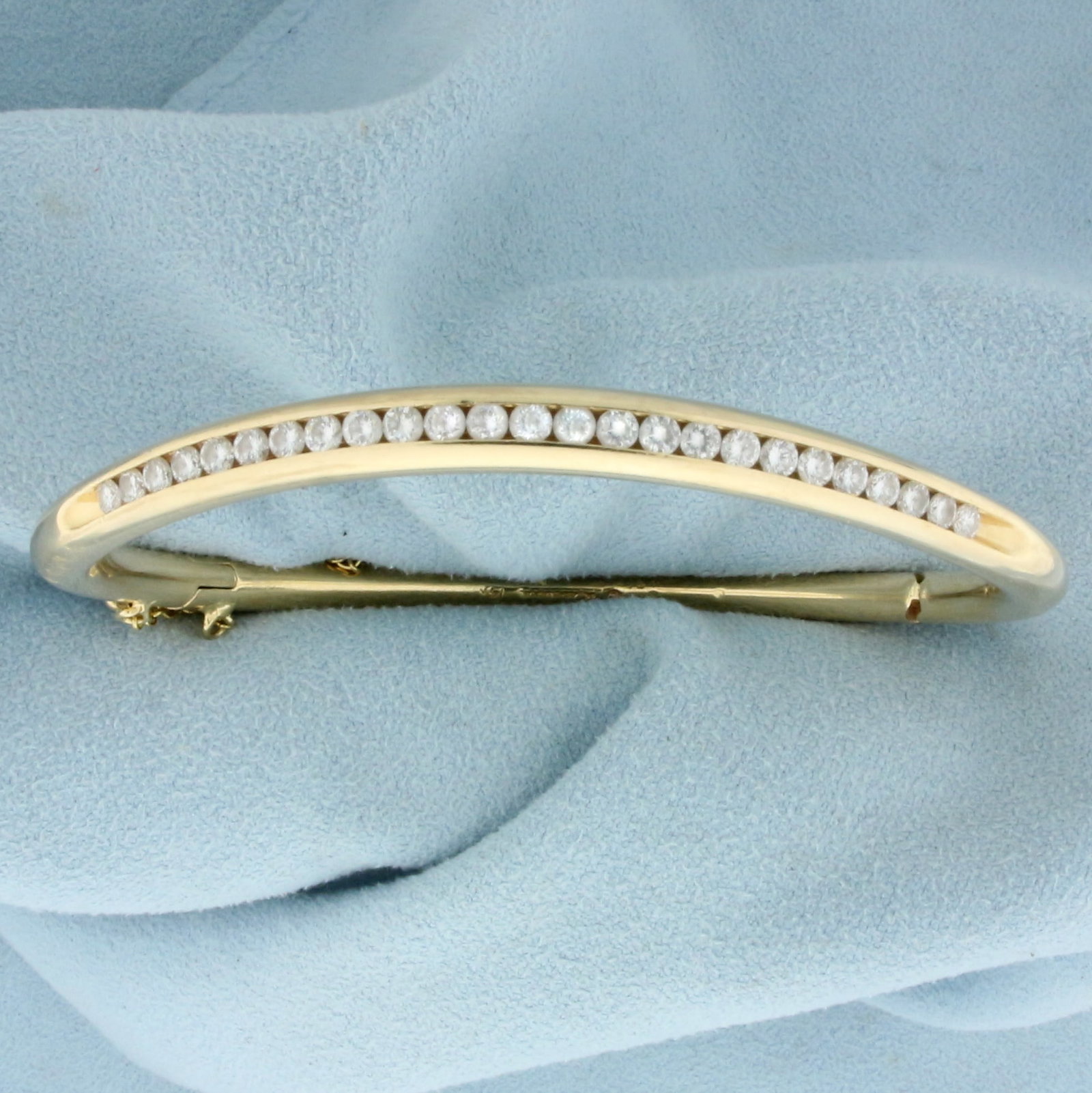 1ct TW Diamond Bangle Bracelet in 14K Yellow Gold: In 14K Yellow Gold. Contains twenty five high quality diamonds, 1ct TW, VS clarity/G color. 2 1/4 inner diameter. 5mm wide. Opens/closes for easy putting on and taking off. Safety chain. 32.4g