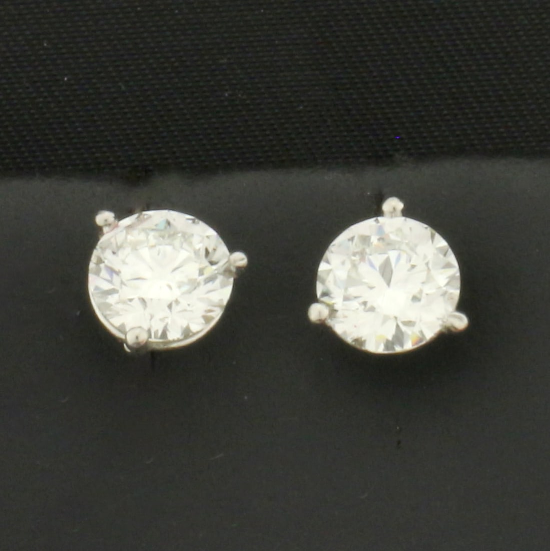 GIA Certified 2ct TW Diamond Stud Earrings in Platinum Martini Settings: In platinum settings with platinum friction backs. Contains two 1ct GIA certified round brilliant diamonds, J color/SI2 clarity, excellent cut for lots of sparkle.