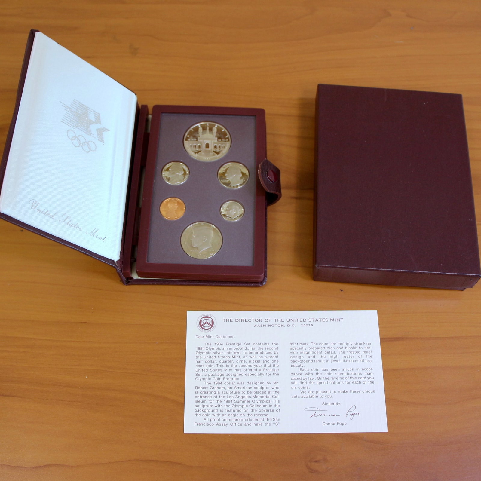 United States Mint 1984 Olympic Silver Proof Prestige Coin Set Box and COA: 1984 Olympic Prestige Set of 6 coins. Contains 19844 90% Silver Olympic Silver Dollar Coin. Includes box and COA