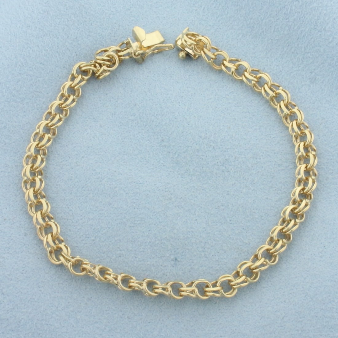 Double Cable Link Charm Bracelet In 14k Yellow Gold: In 14k Yellow Gold. 7 inches long. 4.8mm wide. Slide clasp with safety latch. 7.5g.