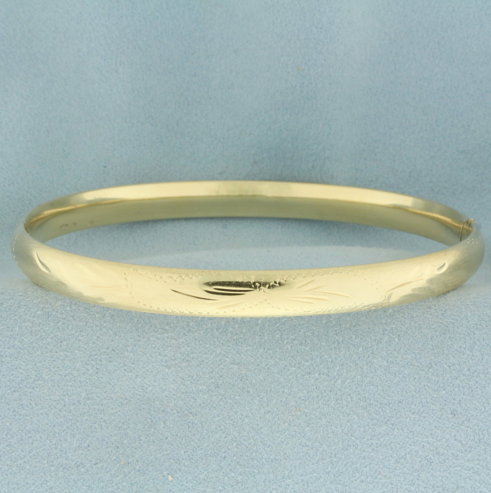 Leaf Design Hinged Bangle Bracelet in 14k Yellow Gold: In 14k Yellow Gold. Interior dimensions: 2.5 inch x 2 3/8 inches. 6.3mm wide. Hinged slide closure. 8.2g.