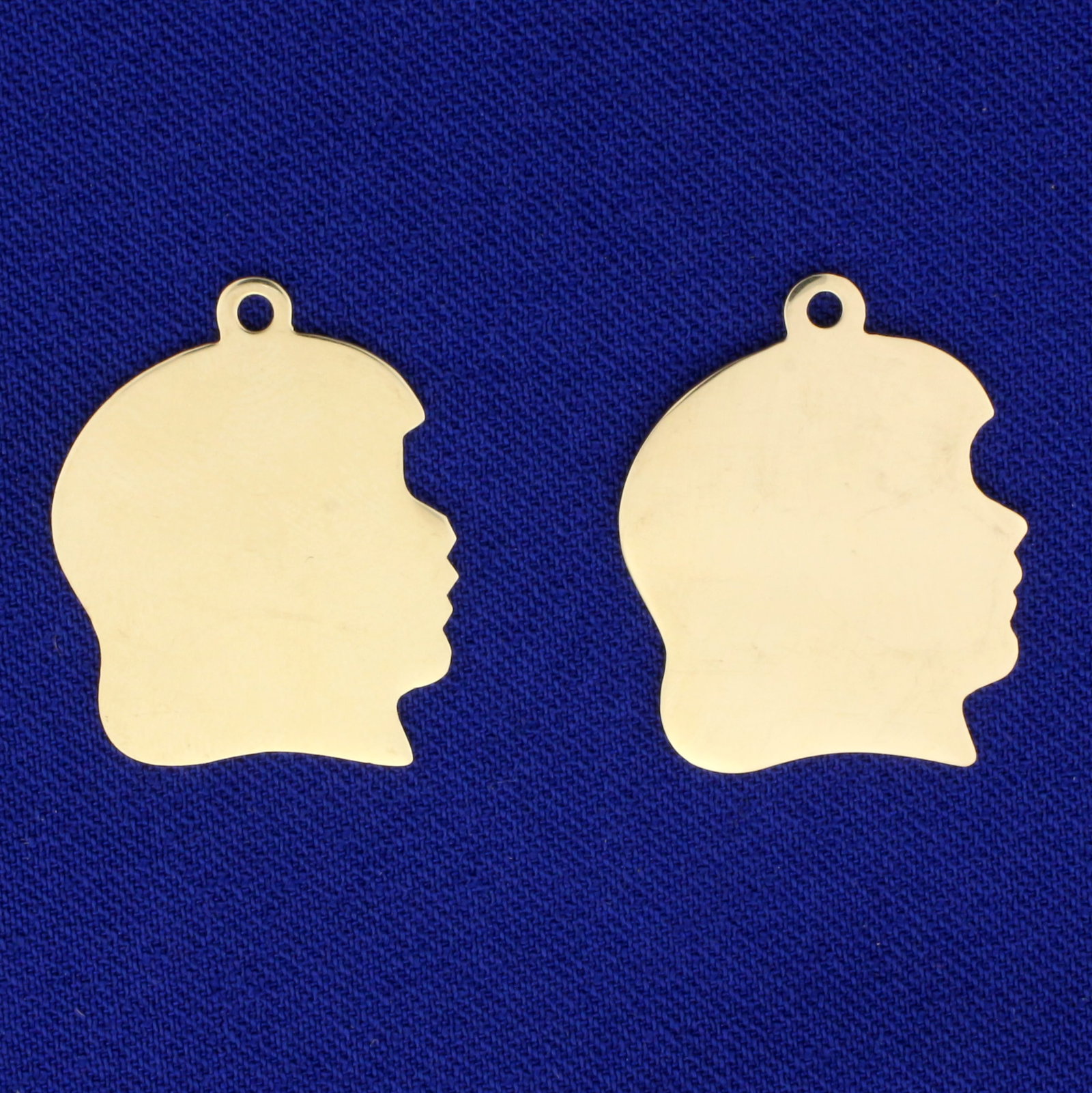 2 Girl Silhouette Pendants or Charms in 14K Yellow Gold: In 14K Yellow Gold. 1 inch long including bale, 3/4 inch wide. 4.6g.