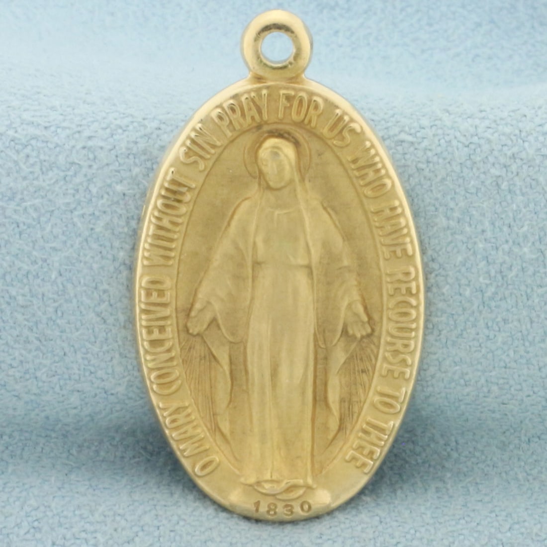 Miraculous Virgin Mary Religious Pendant in 14k Yellow Gold: In 14k yellow gold. 1 1/4 inches long and 5/8 inches wide. 6.4g.