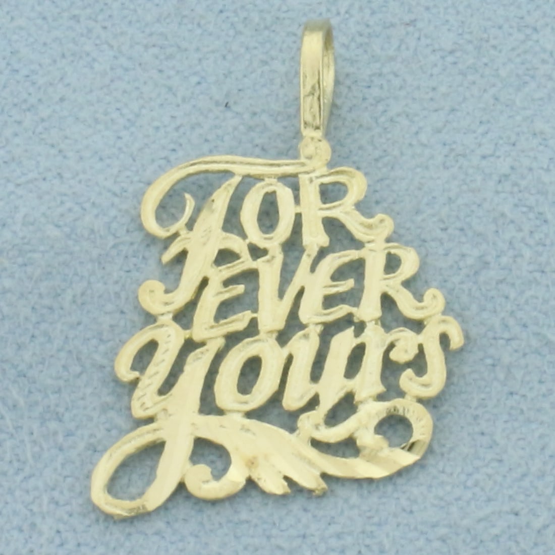 Forever Yours Pendant in 14k Yellow Gold: In 14k Yellow Gold. 1 inch long. 5/8 inch wide. 0.9g.
