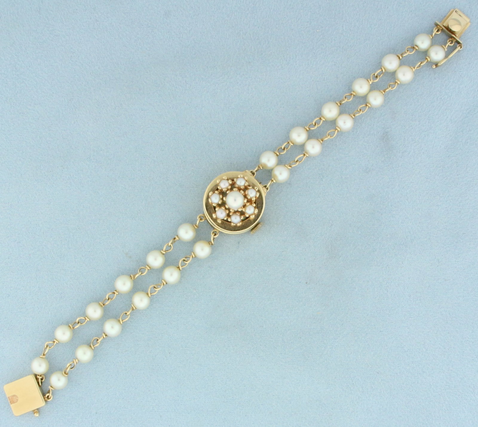 Vintage Honora Akoya Cultured Pearl Concealed Watch in 14k Yellow Gold: In 14k yellow gold. Contains thirty two 3mm to 5mm cultured Akoya Honora pearls with beautiful creamy white color. Case is 3/4 inch in diameter including crown. Wind up movement runs great. 6 3/4 inch