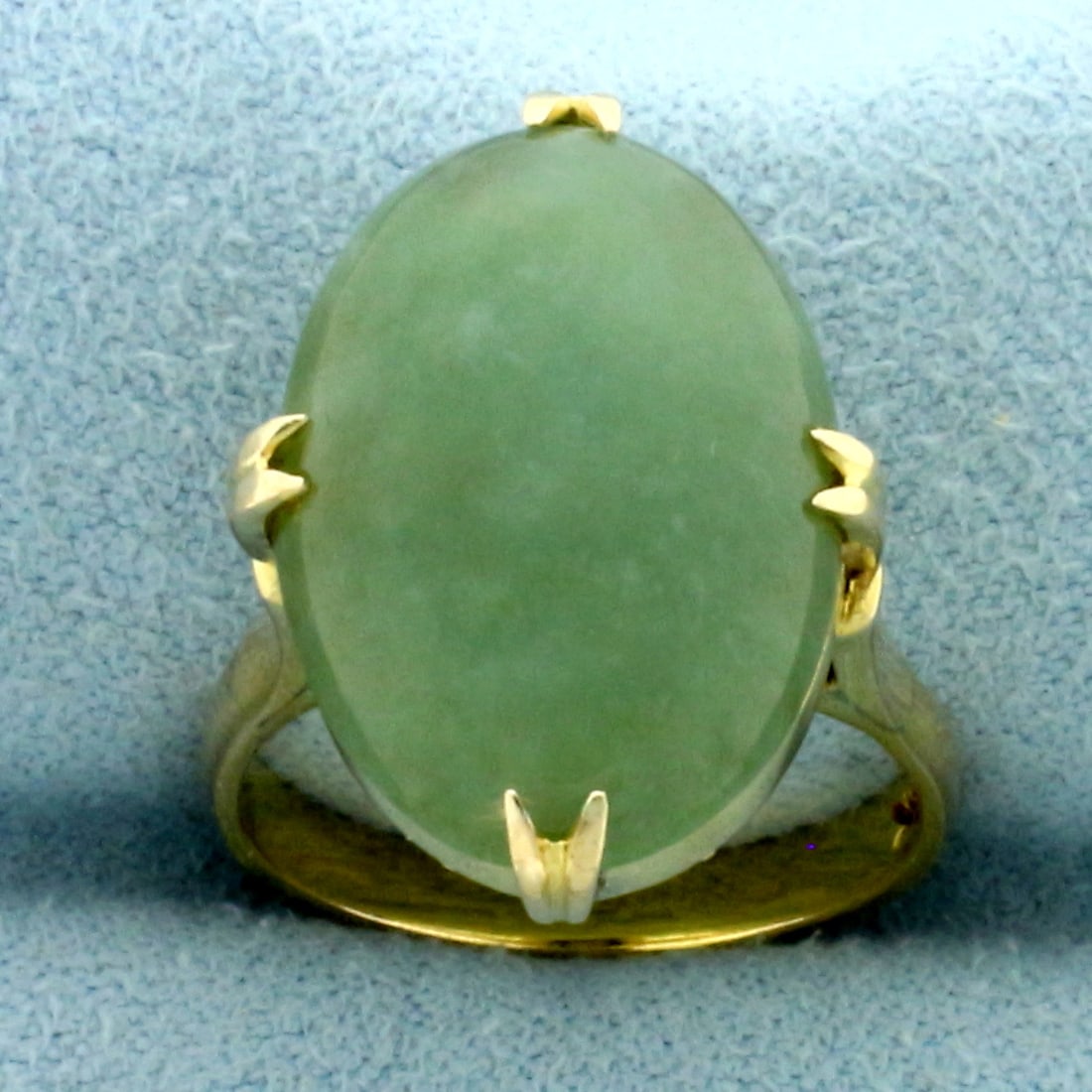 Jade Solitaire Statement Ring in 14k Yellow Gold: In 14k yellow gold. Contains one high quality natural 10ct 19mm x 13mm jade gemstone with uniform intense green color and excellent clarity. Size: 6. 6.8g.