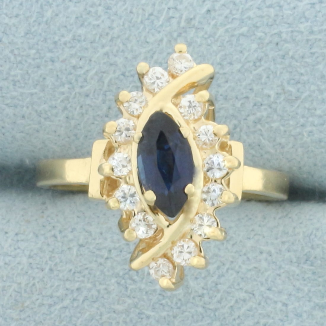 Marquise Sapphire and Diamond Ring in 14k Yellow Gold: In 14k yellow gold. Contains one high quality natural 7mm by 4mm marquise sapphire gemstone with intense blue color and excellent clarity. Also contains fourteen high quality .03ct diamonds, VS clarit