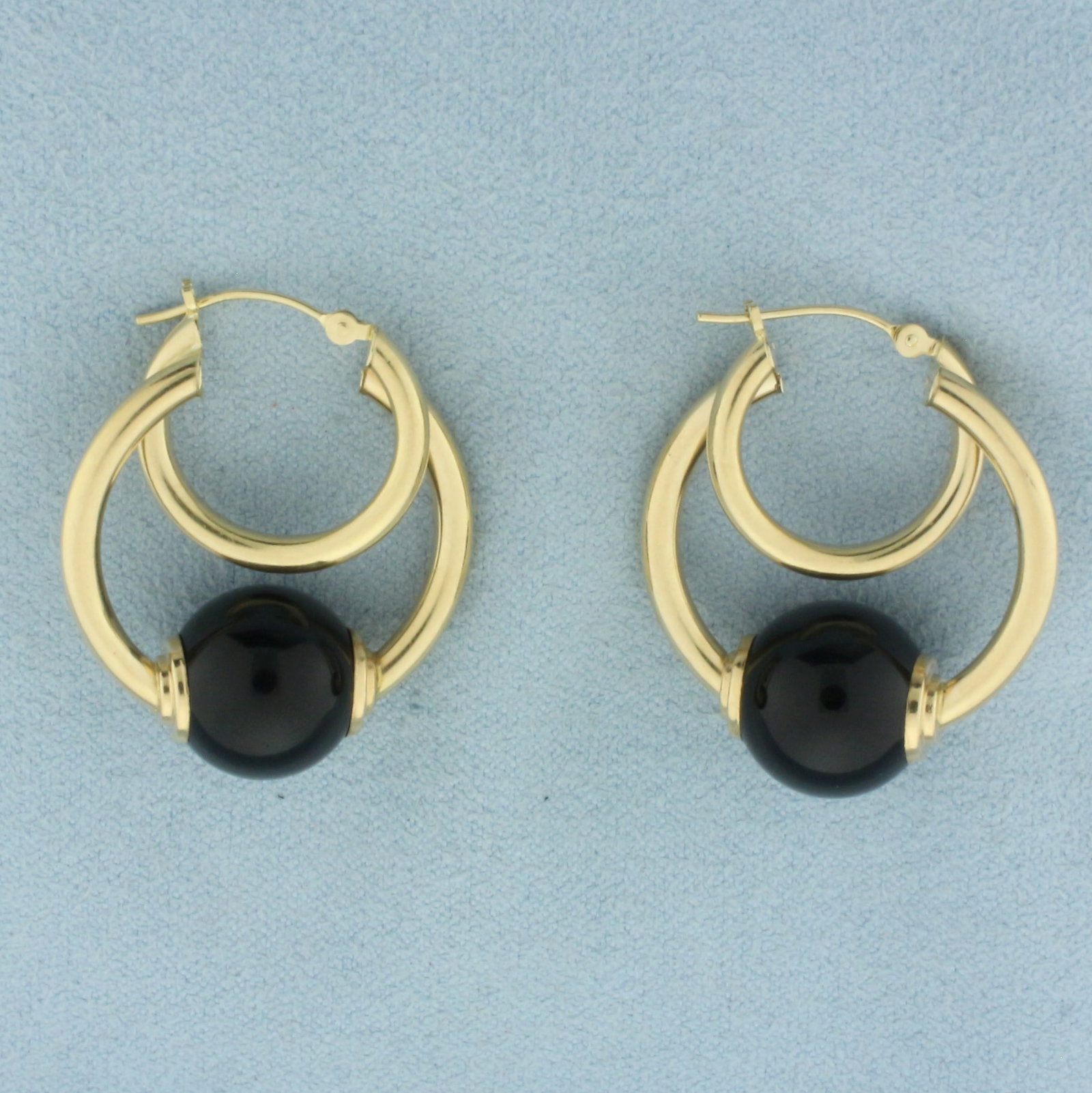 Onyx Double Hoop Earrings in 14k Yellow Gold: In 14k Yellow Gold. Contains two 12mm onyx beads. 1 1/8 inch long. 1 inch wide. Very small indentation on one hoop. 7.2g.