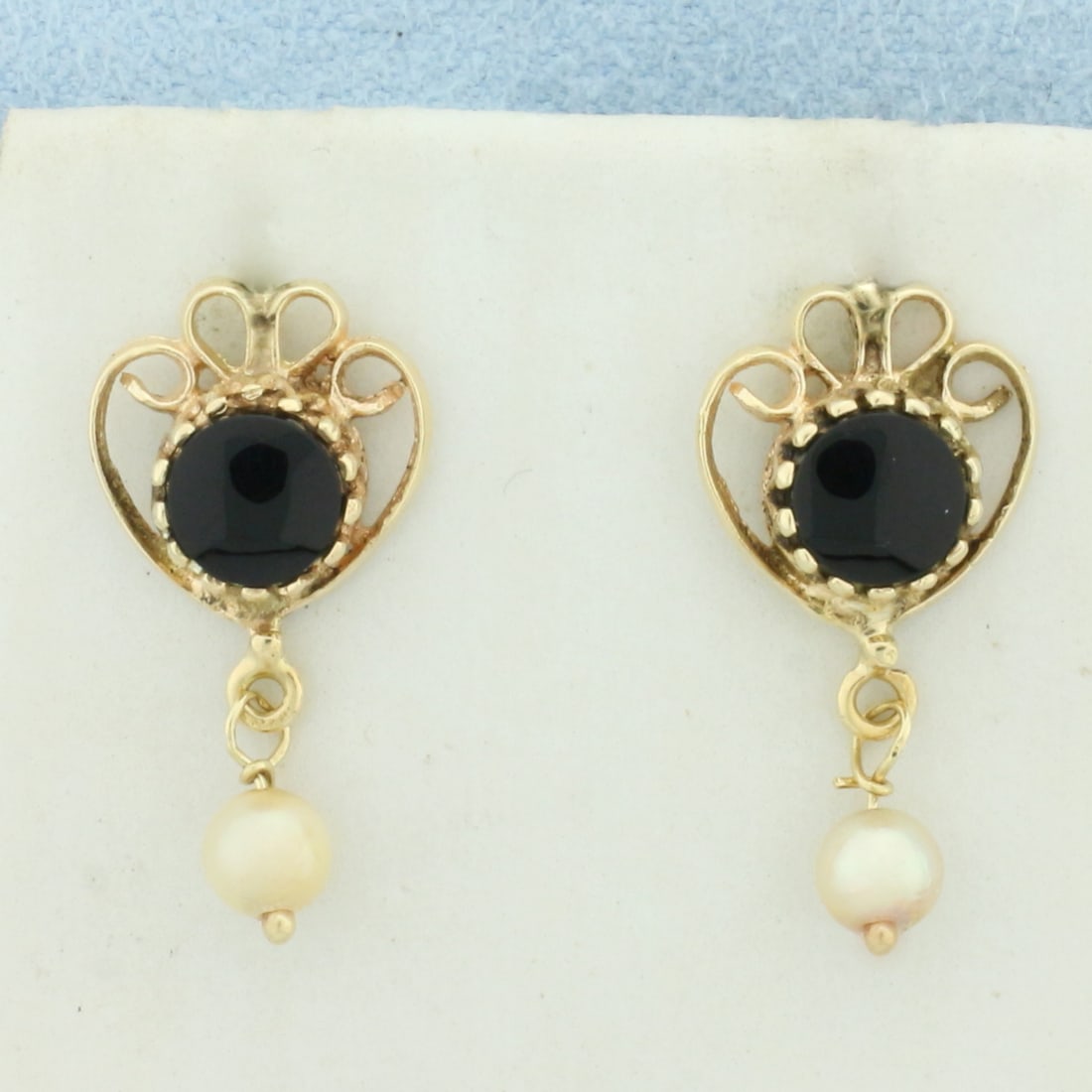 Vintage Onyx and Pearl Heart Dangle Earrings in 14k Yellow Gold: In 14k Yellow Gold. Contains two high quality 4mm cultured pearls with high luster. Also contains two 7mm onyx gemstones . 3/4 inch long. 1/2 inch wide. Friction backs. 2.5g.