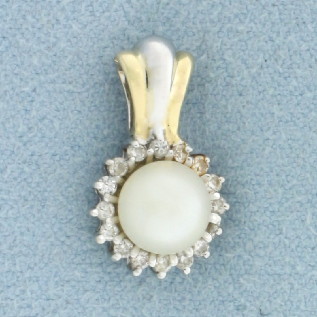 Akoya Pearl and Diamond Pendant in 14k Yellow and White Gold: In 14k Yellow and White Gold. Contains one high quality 6.4mm cultured akoya pearl with high luster. Also contains sixteen high quality 1/2pt diamonds. 5/8 inch long. 3/8 inch wide. 1.9g.