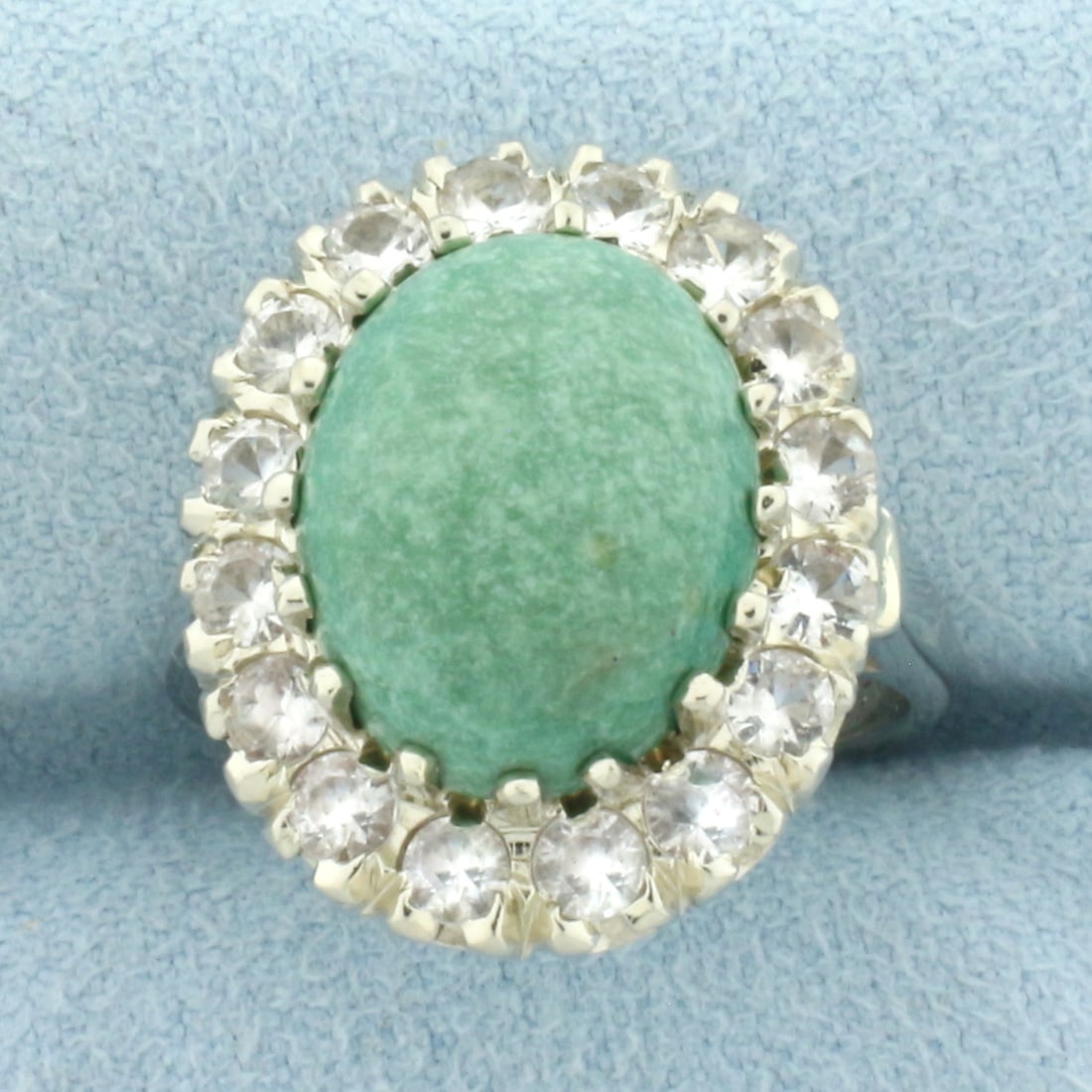 Jade and White Sapphire Halo Ring in 14k White Gold: In 14k White Gold. Contains one high quality natural 13.5mm x 11mm Jade gemstone. Also contains sixteen high quality white sapphire gemstones, 1ct TW, with excellent cut and clarity for added brillian