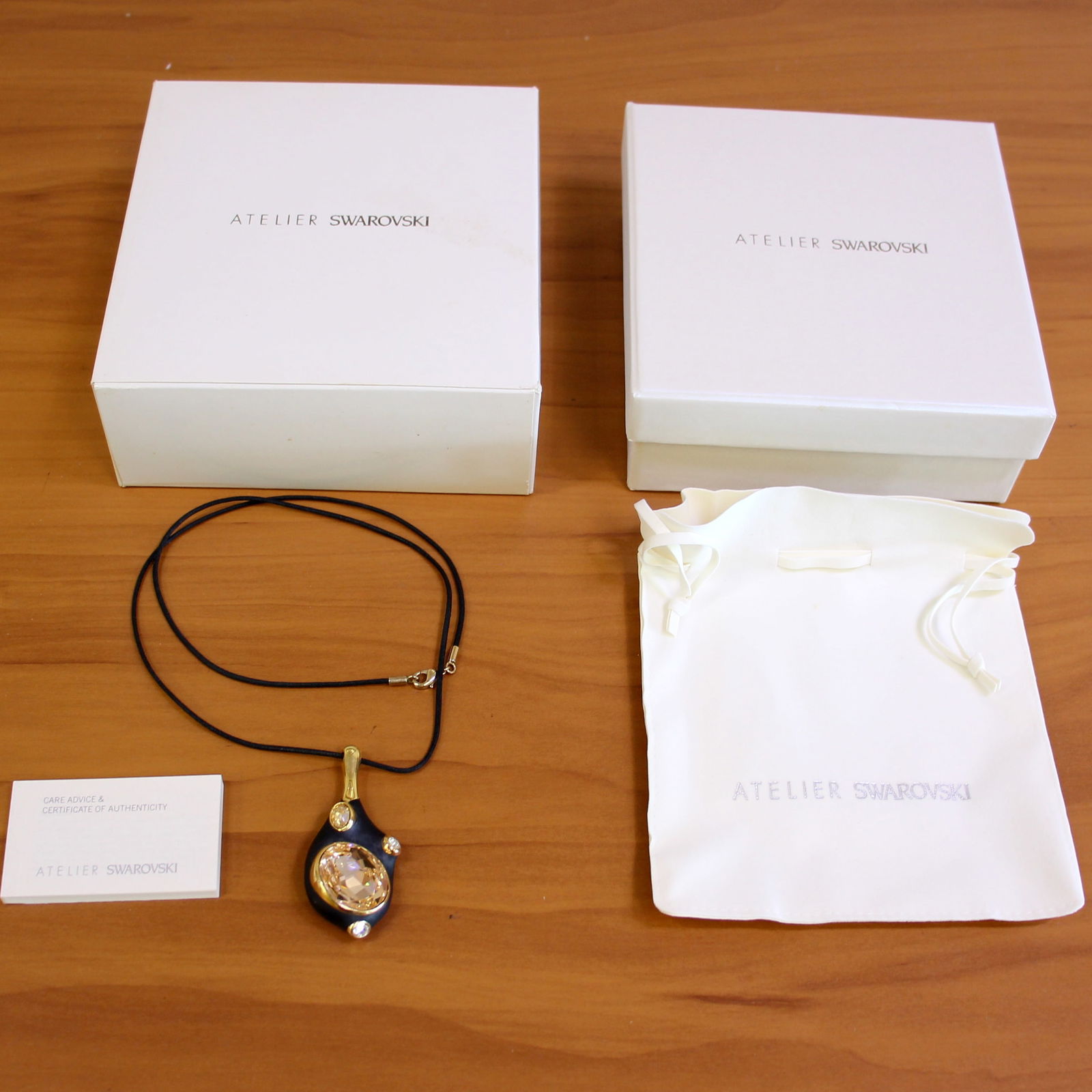 Atelier Swarovski By Greg Lynn Zuma Pendant Necklace: Black/gold colorway. Gold plated, Swarovski crystal. Pendant is 2 1/8 inches x 1 1/8 inches. 26 inches long. Includes box, pouch, authenticity certificate.