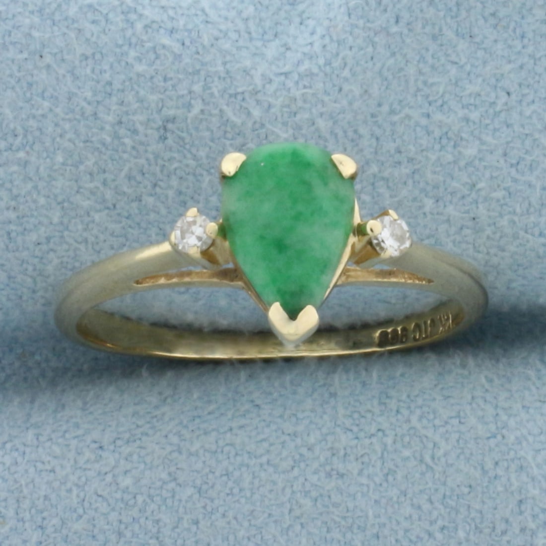 Jade and Diamond Ring in 14k Yellow Gold: In 14k Yellow Gold. Contains one high quality natural 9mm pear Jade gemstone with intense color. Also contains two .03ct high quality diamonds, VS clarity/H color. Size 8. 2.2g.