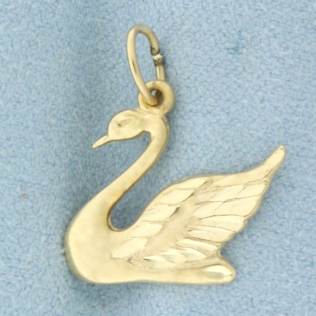 Diamond Cut Swan Charm or Pendant in 14k Yellow Gold: In 14k Yellow Gold. 3/4 inch long including jump ring. 3/4 inch wide. 1.4g.