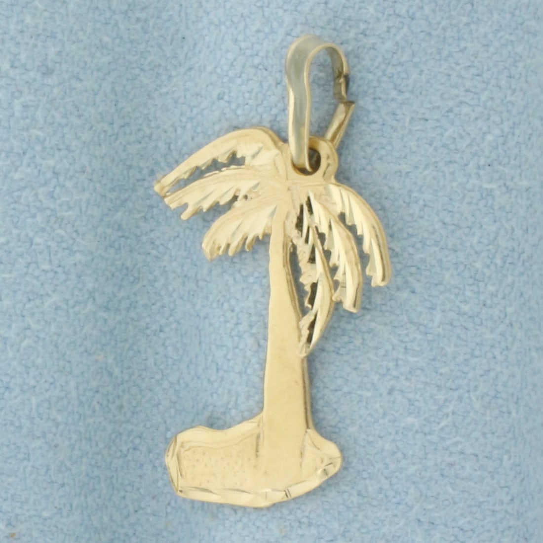 Diamond Cut Palm Tree Pendant or Charm in 14k Yellow Gold: In 14k Yellow Gold. 1 inch long. 1/2 inch wide. 1.0g..