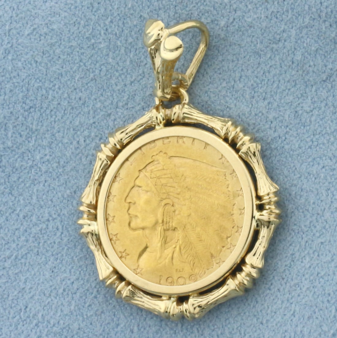 Bamboo Frame 1909 Indian Head 2 1/2 Dollar Gold Coin Pendant: 14k Yellow Gold pendant. Contains one 1909 2 1/2 dollar Indian Head gold coin. 1 1/4 inch long. 7/8 inch wide. 7.8g.