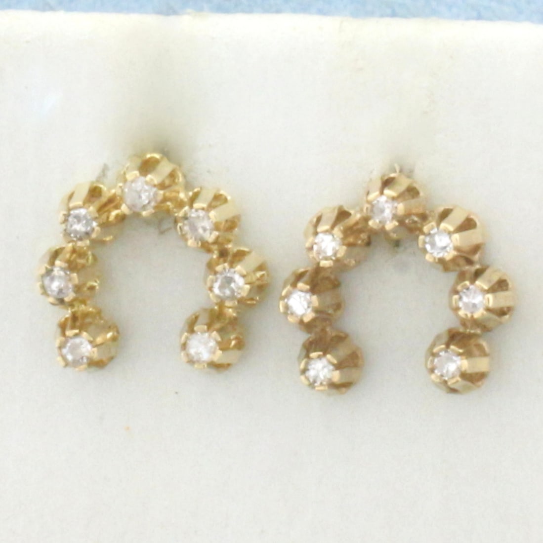 Antique Diamond Horseshoe Earrings in 14k Yellow Gold: In 14k Yellow Gold. Contains fourteen high quality .01ct diamonds, SI clarity/H color. 3/8 inch long. 3/8 inch wide. Friction backs. 1.1g.