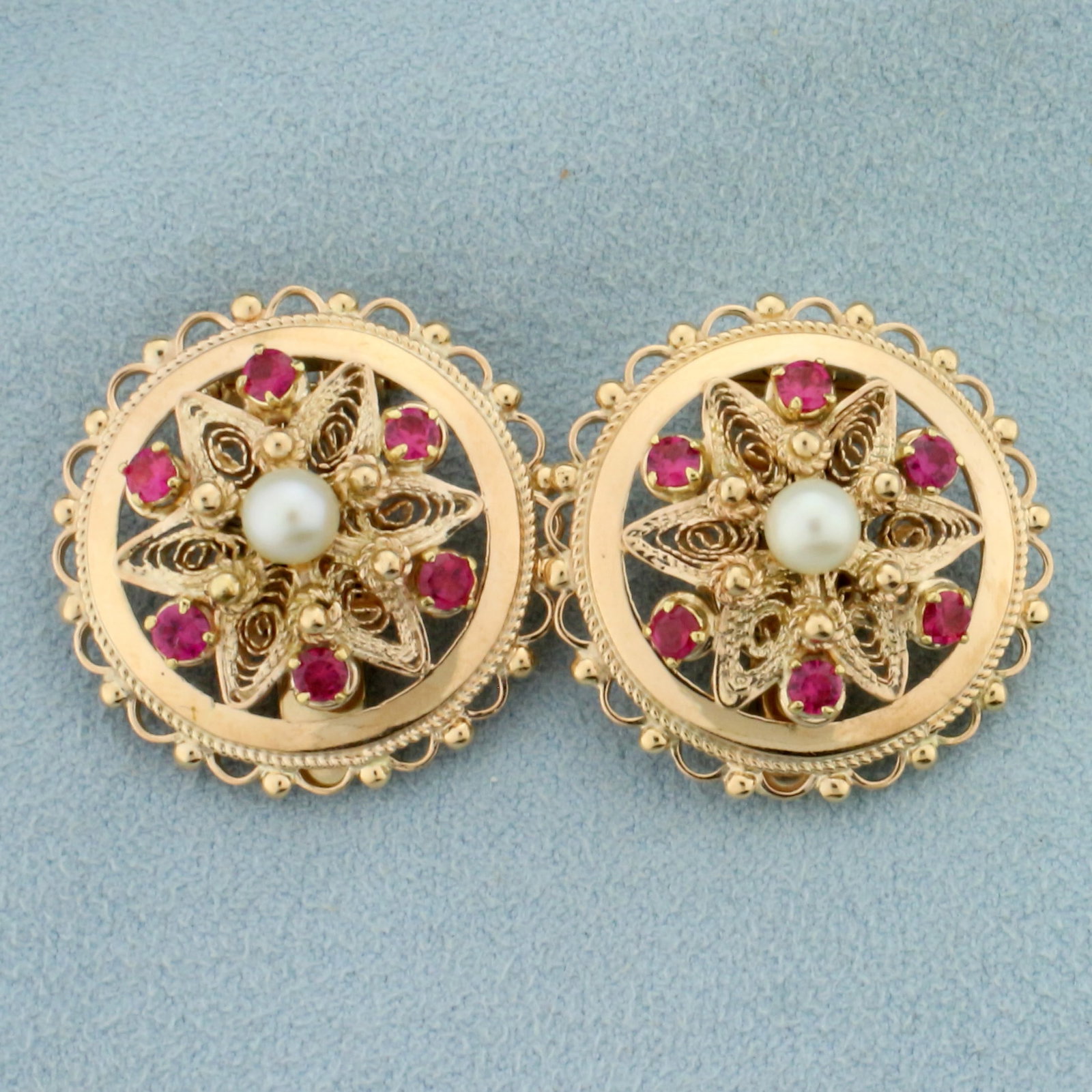Vintage Ruby and Pearl Disc Clip On Earrings for in 14K Yellow Gold: In 14K Yellow Gold. Each earring contains one high quality natural 4.5mm Cultured Pearl with high luster. Each earring also contains six 2.5mm high quality natural Ruby gemstones with vibrant color an