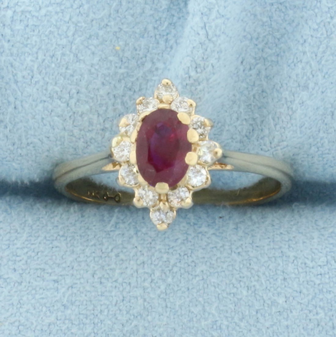 Ruby and Diamond Ring in 14k Yellow Gold: In 14k Yellow Gold. Contains one natural high quality 6mm Ruby gemstone with intense color and excellent clarity. Also contains twelve high quality diamonds, 1/4ct TW, SI clarity/I color. 12mm wide at